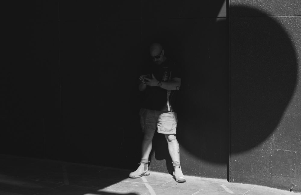 Worker on a job site in heavy shadow, illustrating a workers compensation fraud case study